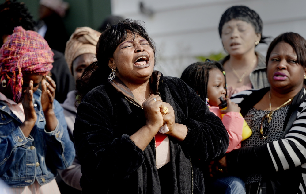 Ana Mavungo sings during a memorial for her friend Laudrinha Kubeloso, who was struck and killed in a hit-and-run Tuesday in Lewiston. Kubeloso's friends and neighbors gathered on Howe Street on Thursday.
