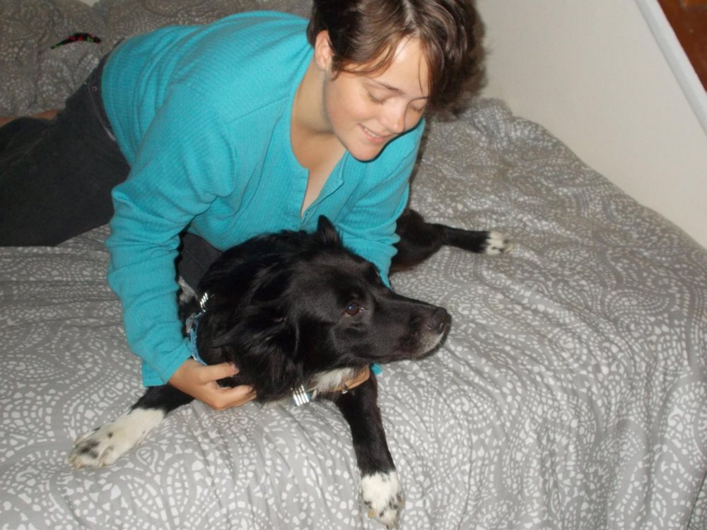 Kerstie Bush of Bangor plays with her dog, Running Bear.