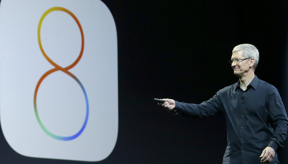Apple CEO Tim Cook speaks about iOS 8 at the Apple Worldwide Developers Conference in San Francisco in June. Apple has stopped providing an update to its new iOS 8 mobile operating software after complaints that it interferes with their ability to make phone calls.