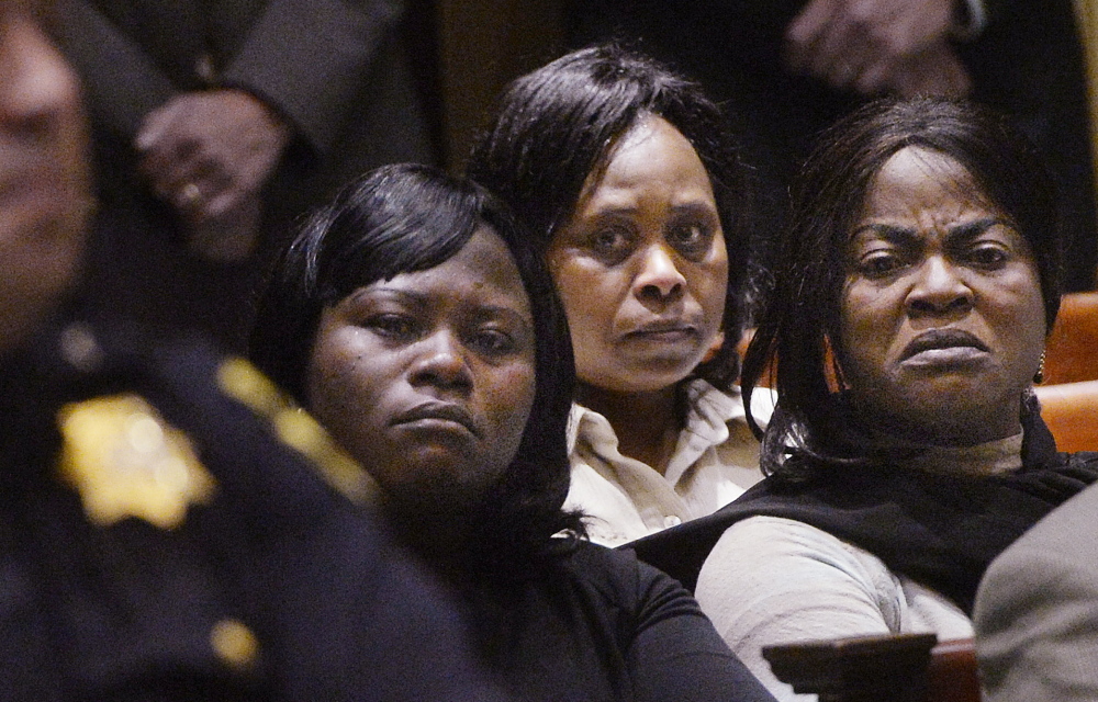 Women from the African immigrant community look toward Evaristo Deus on Friday as he arrives at a court hearing in 2014, where he was charged with the murder of Laudrinha Kubeloso. He was sentenced Tuesday.