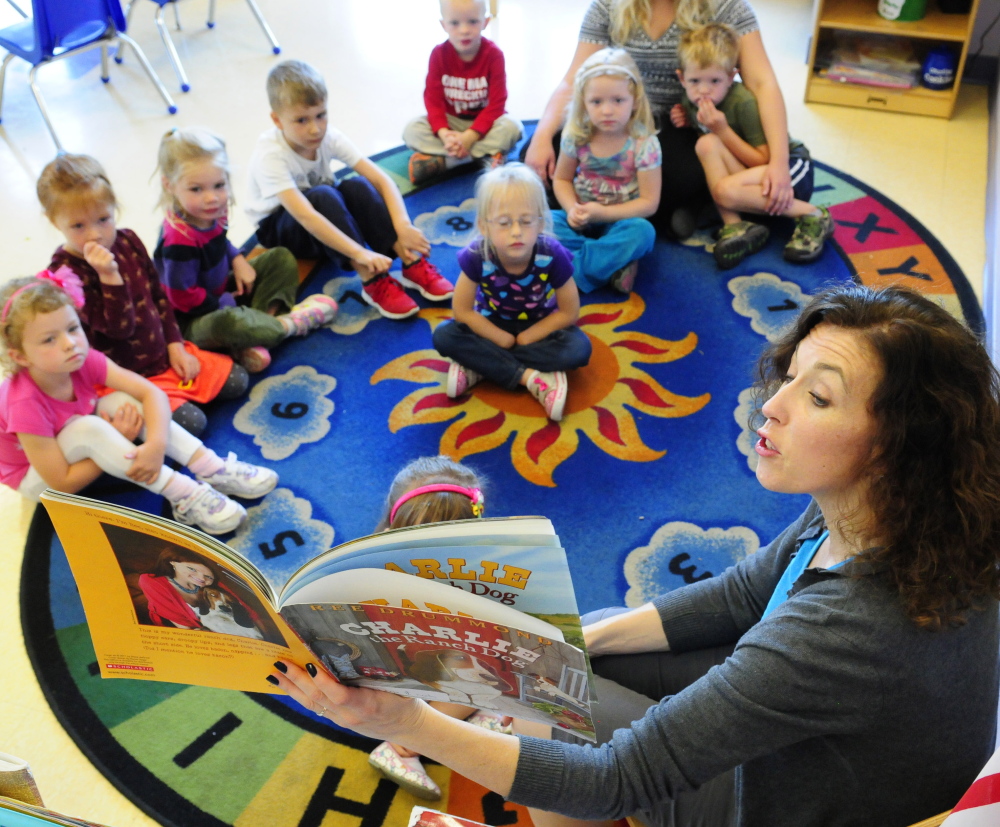Susanne Murphy reads a book to a group of her 4-year-old students Friday at the Kennebec Valley YMCA in Augusta. The YMCA is helping Lithgow Public Library raise money.