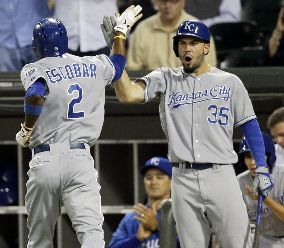 Alcides Escobar, left, of the Royals celebrates with Eric Hosmer after scoring during Friday’s win in Chicago that ended the team’s long playoff drought.