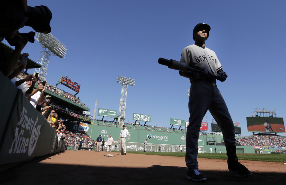 New York Yankees designated hitter Derek Jeter walks to the on-deck circle as he prepares to face the Boston Red Sox in the first inning Saturday at Fenway Park.