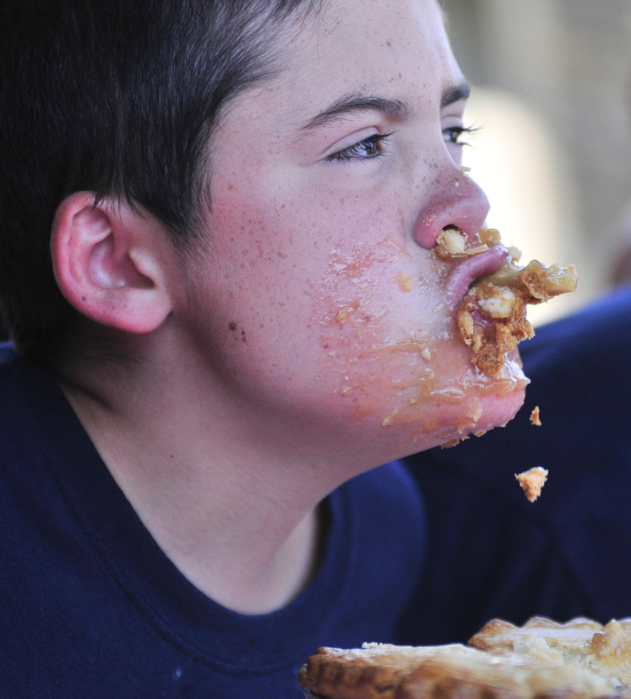 Ethan Larabee, 14, of Monmouth competes in the apple pie-eating contest on Saturday during the Monmouth AppleFest.