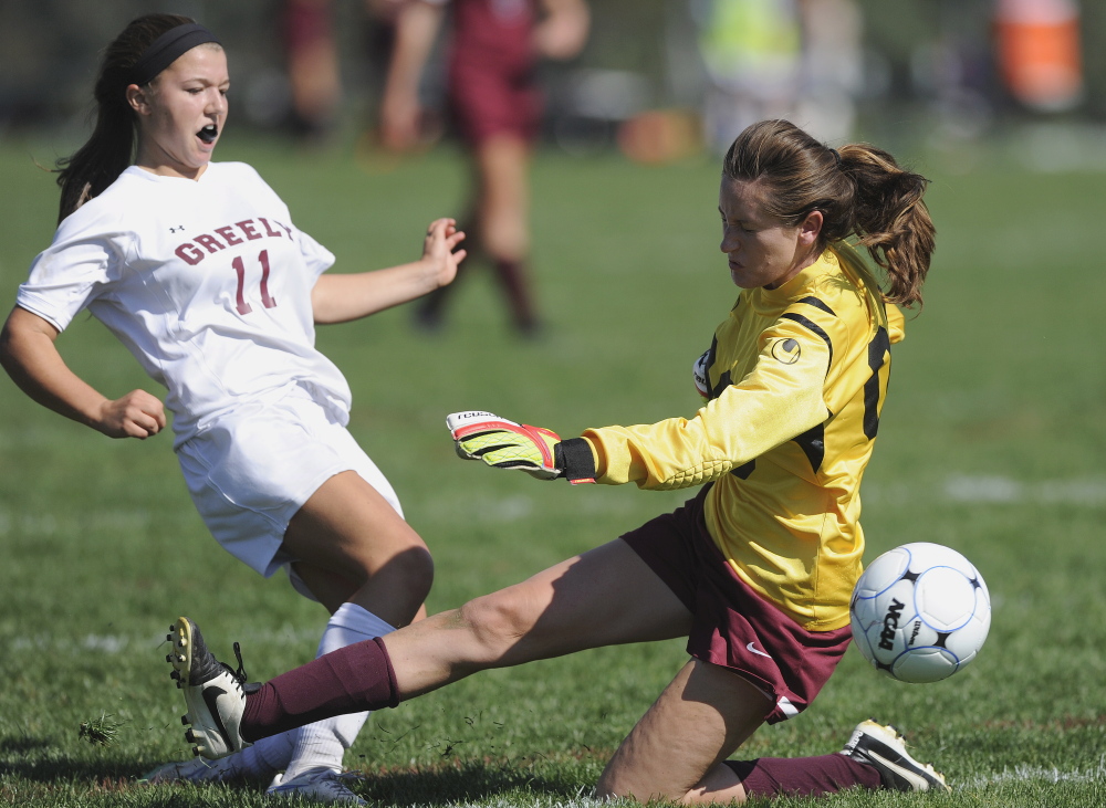 Freeport goalkeeper Izzy Qualls deflects a scoring bid by Ellie Schad of Greely during their Western Maine Conference girls’ soccer game Saturday. Undefeated Greely won its seventh game with a 3-0 victory.