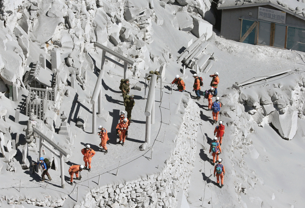 Firefighters advance to rescue climbers near the peak of Mount Ontake in central Japan on Sunday Mount Ontake erupted shortly before noon Saturday, spewing large white plumes of gas and ash high into the sky and blanketing the surrounding area in ash.
