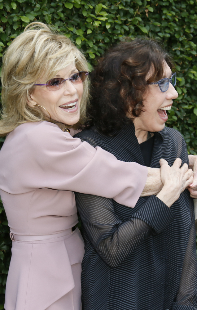 Actress and event host Jane Fonda, left, and actress Lily Tomlin embrace at The Rape Foundation’s annual brunch.