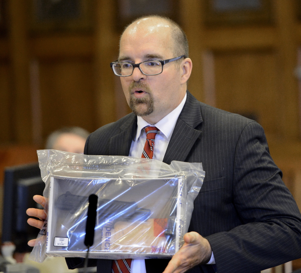 Assistant Attorney General Donald Macomber shows the jury the alleged murder weapon during opening statements Monday in the trial of Anthony Pratt Jr.