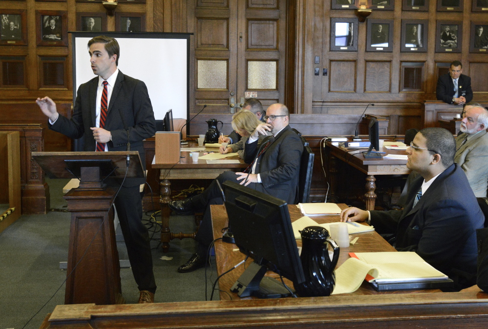 Defense attorney Dylan Boyd presents his opening statement Monday to the jury in the murder trial of Anthony Pratt Jr., seated lower right, at the Cumberland County Courthouse in Portland.