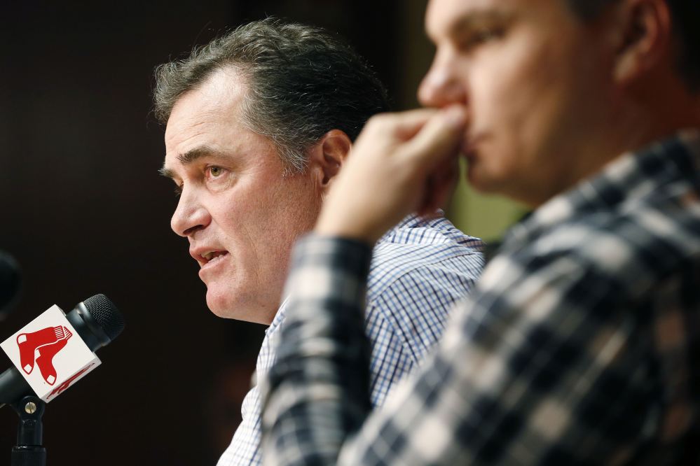 Boston Red Sox manager John Farrell, left, and general manager Ben Cherington take questions during a news conference at Fenway Park on Monday. A year after winning their third World Series in 10 years, the 2014 Red Sox finished last in the AL East, becoming the first team in baseball history to go from worst to first and back to worst in three consecutive seasons.