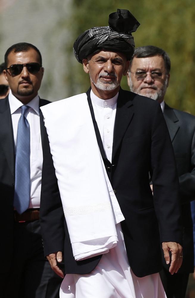 Afghanistan’s new President Ashraf Ghani Ahmadzai, center, arrives for his inauguration ceremony at the Presidential Palace in Kabul, Afghanistan, on Monday.