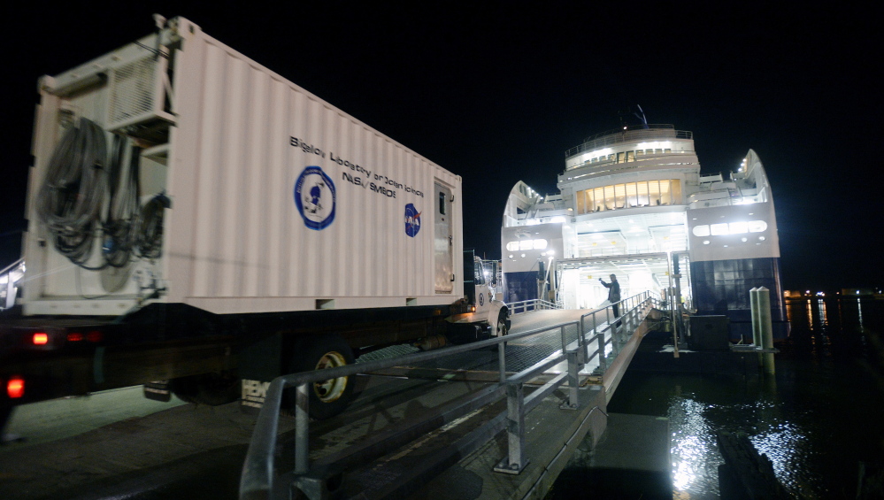 A truck carrying a Bigelow Lab container equipped for research is driven into the lower section of the Nova Star ferry this month. Water samples taken along the ship’s 207-mile route across the Gulf of Maine are used to validate data collected by NASA satellites.