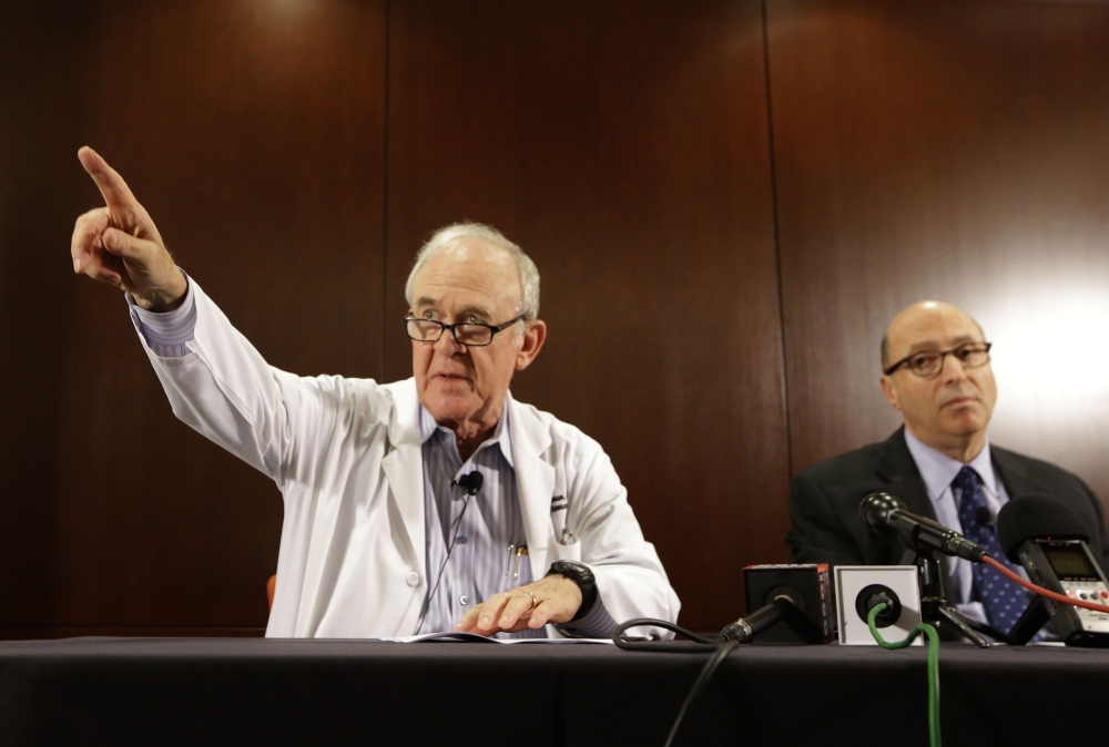 Dr. Edward Goodman, epidemiologist at Texas Health Presbyterian Hospital Dallas, points to a reporter with a question as Dr. Mark Lester looks on during a news conference about an Ebola-infected patient at the hospital. Federal health officials confirmed that it’s the first Ebola case diagnosed in the United States.