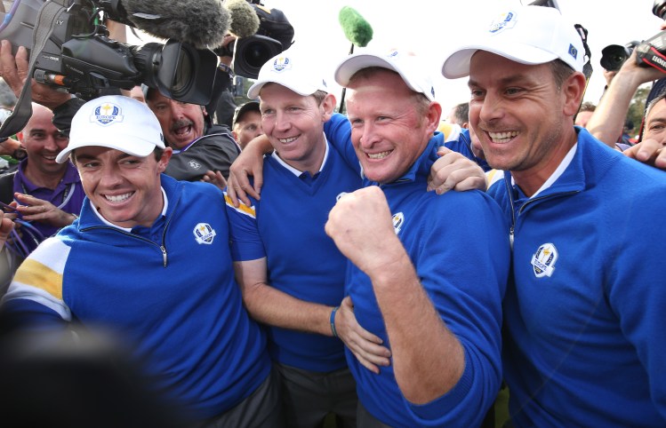 From left, Europe's Rory McIlroy, Stephen Gallacher, Jamie Donaldson and Henrik Stenson  celebrate winning the 2014 Ryder Cup . The Associated Press