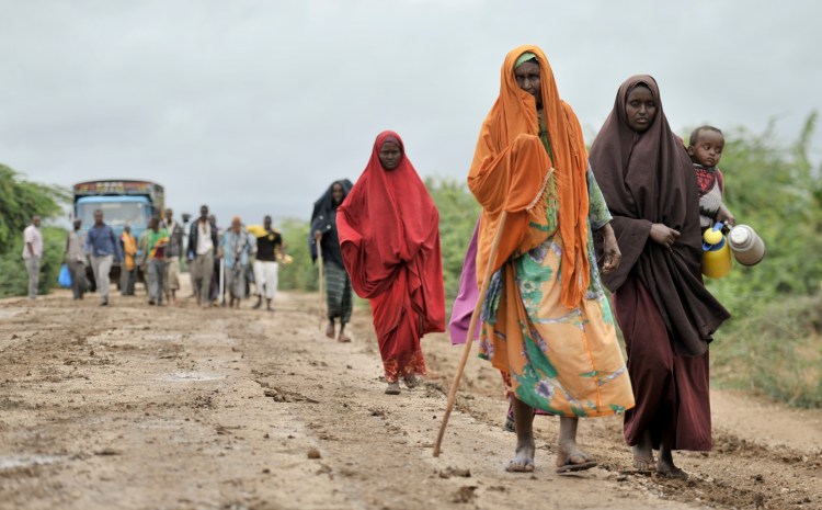 In this photo provided by the African Union Mission to Somalia, civilians who had left the town of Bulomarer when it was held by al-Shabab militants, return Sunday following the town's capture by African Union (AU) and Somali government soldiers. The Associated Press