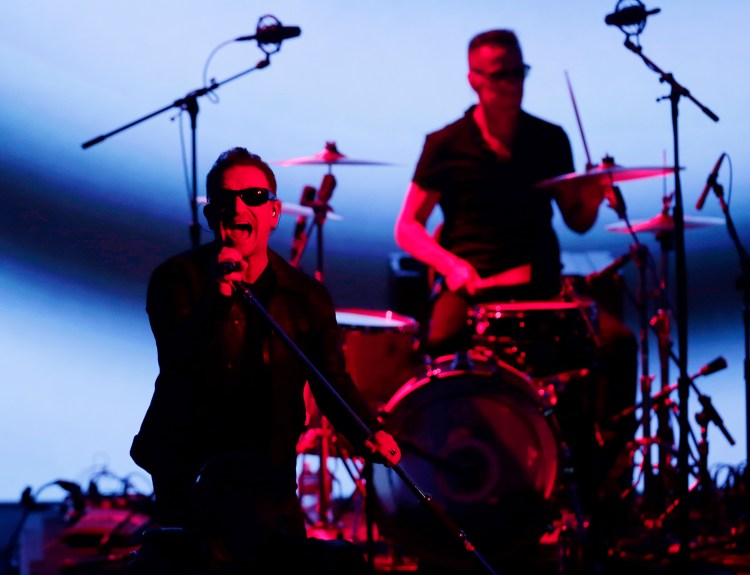 U2 members Bono, left, and Larry Mullen Jr. perform during an announcement of new products by Apple on Tuesday in Cupertino, Calif. The Associated Press