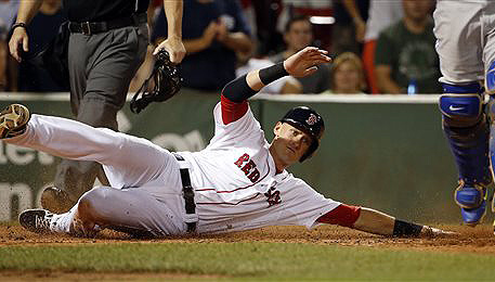Red Sox third baseman Will Middlebrooks slides safely into home on a double by catcher Christian Vazquez on Saturday in Boston. The Associated Press