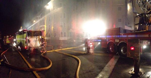 Firefighters battle a fire in the apartment building at 101 Birch St. in Lewiston on Tuesday night.