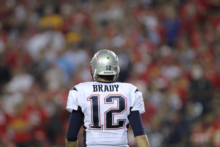 Patriots quarterback Tom Brady looks to the sidelines during the fourth quarter of Monday night's romp by the Kansas City Chiefs. Brady threw two interceptions in the game and lost a fumble.