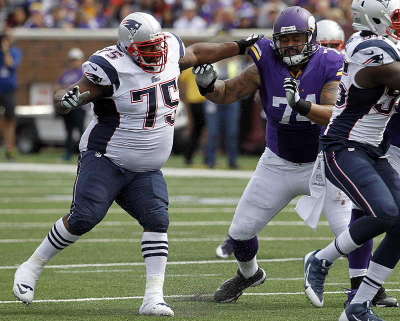 New England Patriots defensive tackle Vince Wilfork, left, defends against Minnesota Vikings offensive guard Charlie Johnson during the third quarter Sept. 14. The Associated Press