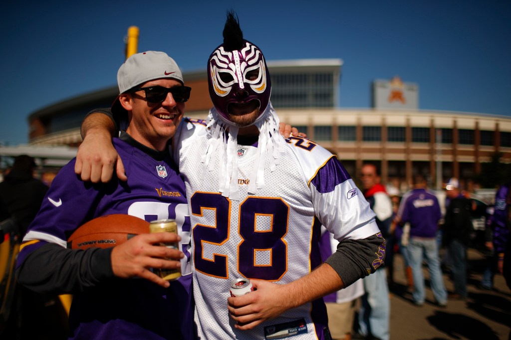 Two fans tailgate outside TCF Bank Stadium wearing Adrian Peterson jerseys before the start of an NFL football game between the Minnesota Vikings and the New England Patriots, Sunday Minneapolis. Peterson's arrest last week jolted the team and the NFL at a time when news of criminal behavior has engulfed the league and brought intense scrutiny.. The Associated Press / St. Paul Pioneer Press