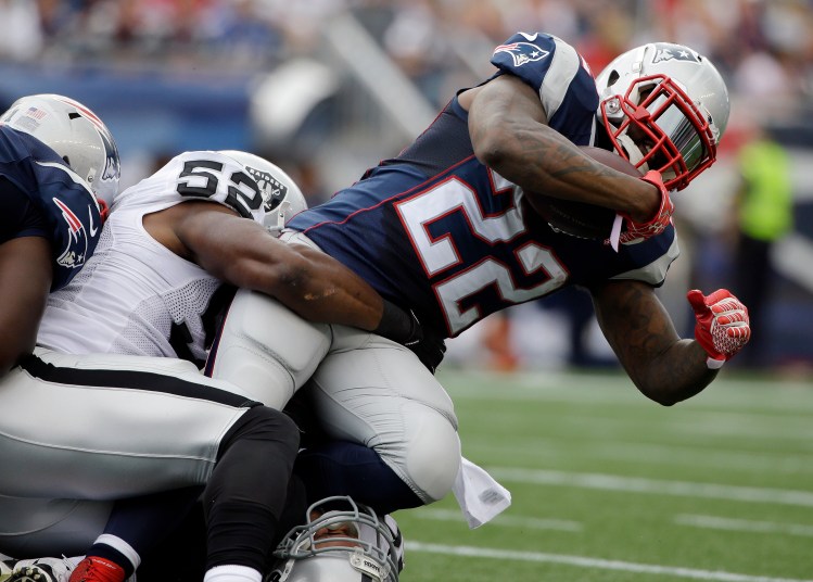 In this file photo, Raiders  linebacker Khalil Mack  Patriots running back Stevan Ridley (in Sunday's game at Foxborough, Mass. The Associated Press
