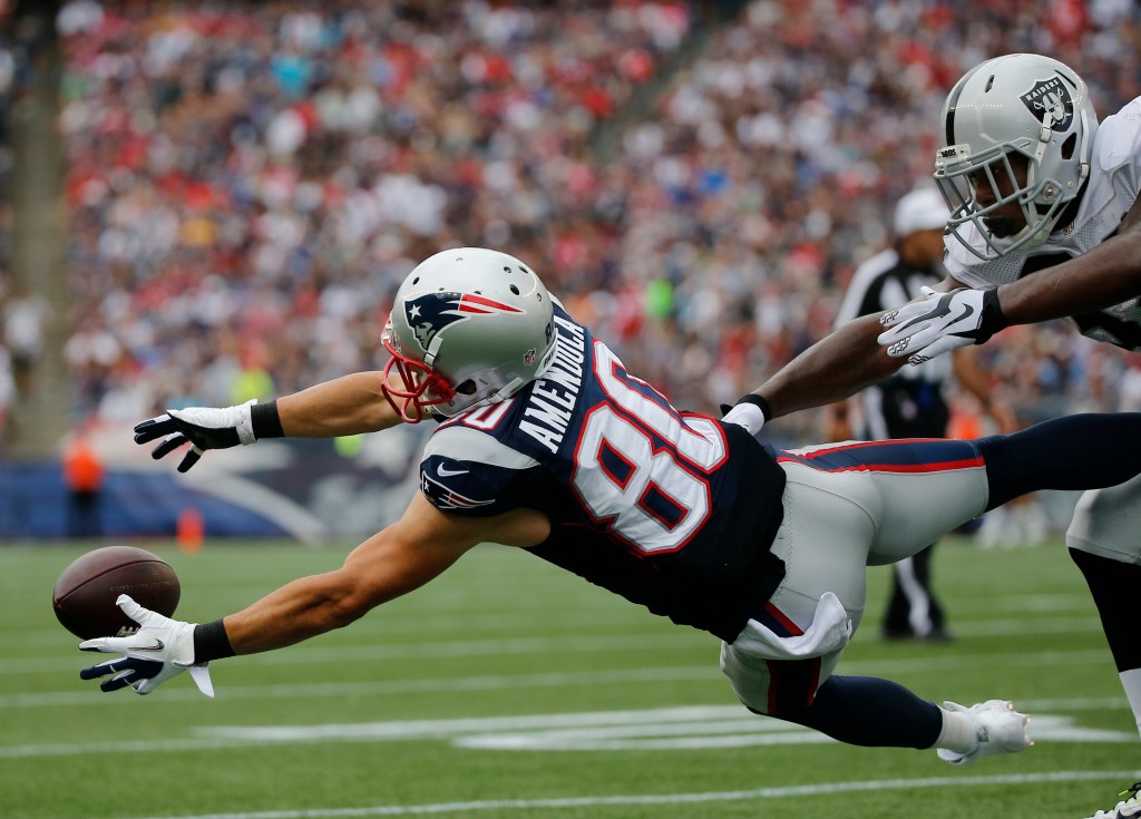 New England Patriots wide receiver Danny Amendola can't catch a pass from quarterback Tom Brady against  the defense of Oakland Raiders cornerback T.J. Carrie (38) during the game Sunday. The Associated Press