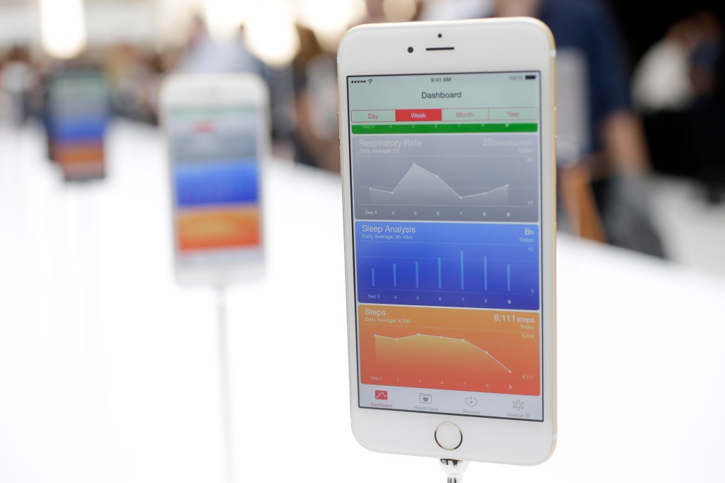 The iPhone 6 Plus displays an app that tracks the owner's physical functioning. The Associated Press