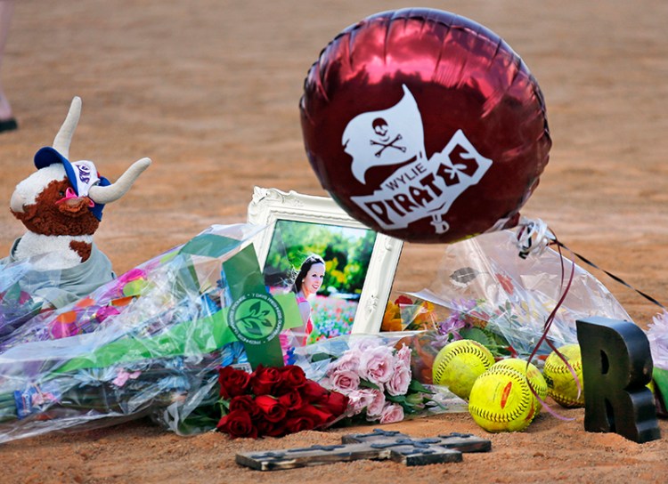 Memorials and flowers were placed on the pitcher's mound at the Wylie (Texas) High School softball field at a vigil held Saturday for Meagan Richardson, 19, one of the softball players killed in a bus crash in Oklahoma on Friday night. The Associated Press