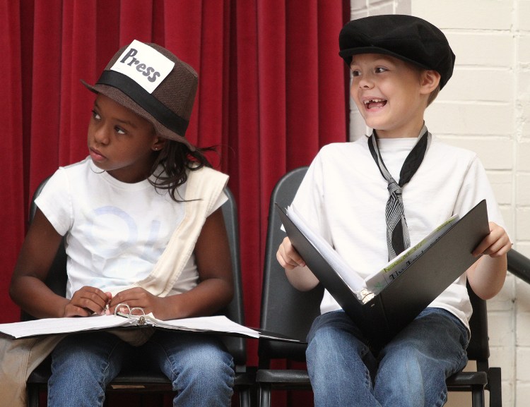 Joshua Rowell laughs during a performance of "The Trial of the Big Bad Wolf" at Clinton Elementary School in Columbus, Ohio, in July. At left is Ta'Nyah Burbage. It was the final part of a five-week summer reading program to help failing third-graders improve their skills so they could be tested again and move on to the fourth grade. The Associated Press