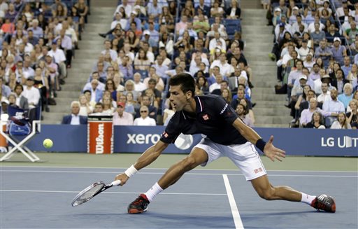 Novak Djokovic of Serbia returns a shot to Andy Murray of Britain in their quarterfinal match at the U.S. Open tennis tournament Wednesday in New York. The Associated Press