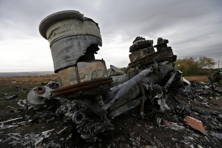 Pieces of the Malaysia Airlines Flight 17 plane are seen near village of Hrabove, eastern Ukraine, Tuesday. Because of the ongoing conflict between pro-Russian rebels and Ukrainian forces, investigators were not able to visit the fields where the wreckage plunged to the ground. That likely contributed to the board's cautious assessment of what happened. The Associated Press