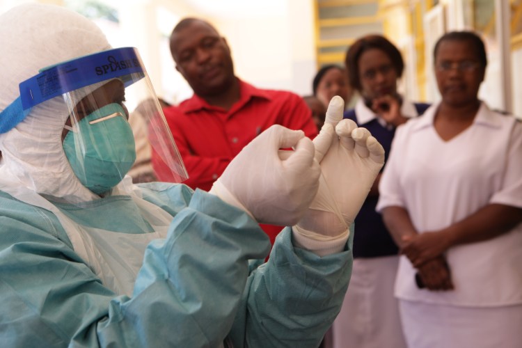 A woman wears protective clothing during a tour  of one of the Ebola Centers in Harare, Zimbabwe Tuesday. Although Zimbabwe has not reported any cases of the deadly virus wreaking havoc in West Africa, it is on high alert and has set up Ebola centers in order to screen people suspected of carrying virus. The Associated Press