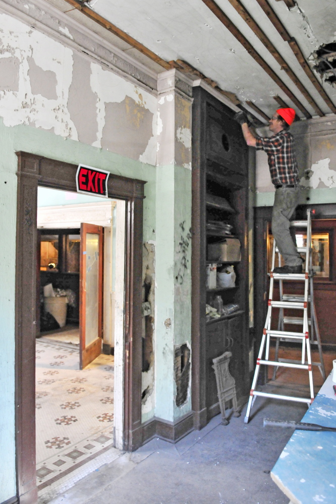 Chris Selwood works in the office of the old Colonial Theater on Oct. 8. He’s a volunteer with a group trying to renovate the theater, which opened in 1913 at 137 Water St. The theater is open 10 a.m. to 2 p.m. Saturday for an open house and tours for the last time this year. Kennebec Journal staff photo by Joe Phelan