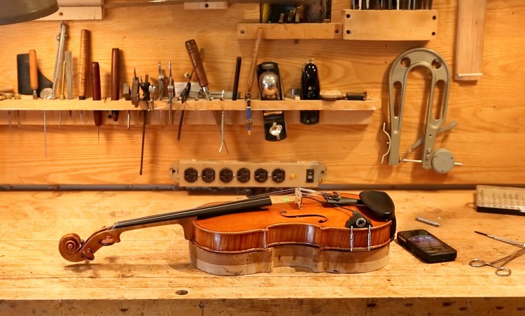 A violin owned by Mark O'Connor, one of the world's pre-eminent fiddlers, under repair in Jonathan Cooper's shop in Portland.