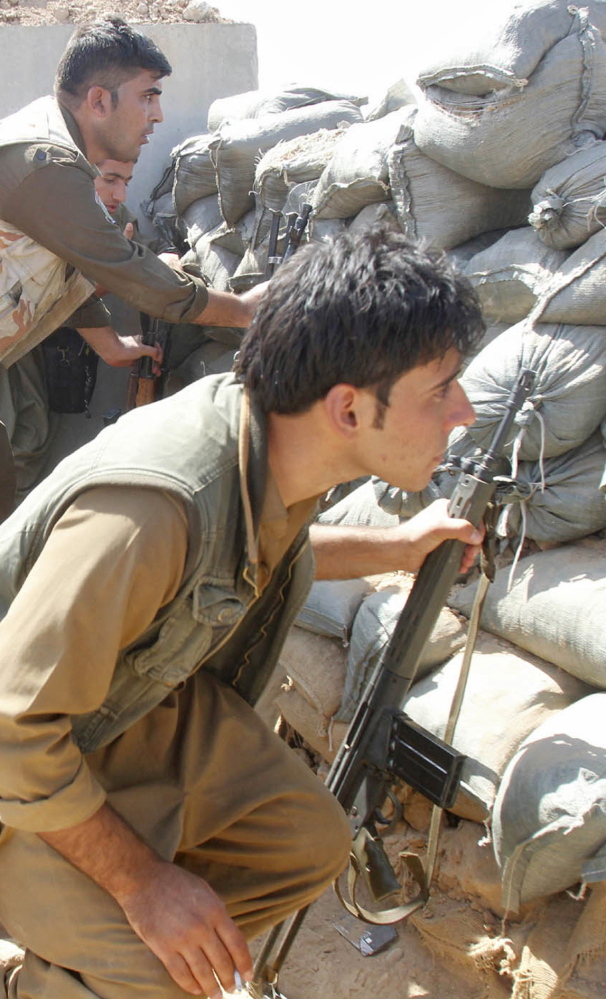 Kurdish peshmerga forces clash with the Islamic State in Daquq, Iraq.