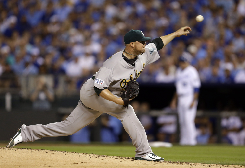 Oakland Athletics starting pitcher Jon Lester throws during the first inning of the AL wild-card playoff game Tuesday night in Kansas City. He took a four-run lead into the eighth inning but Oakland couldn’t hold on.