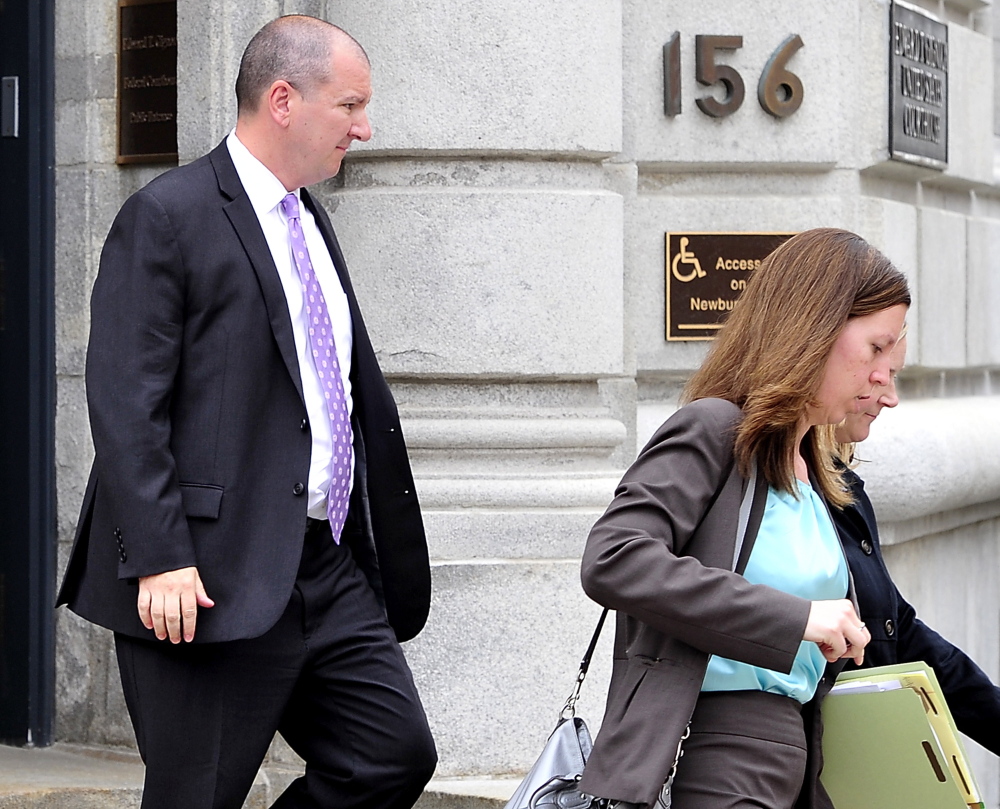 Jeffrey Burnham leaves U.S. District Court in May with his lawyers and family.