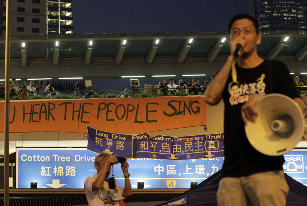 A demonstrator delivers a speech to some of the tens of thousands of protesters in Hong Kong.