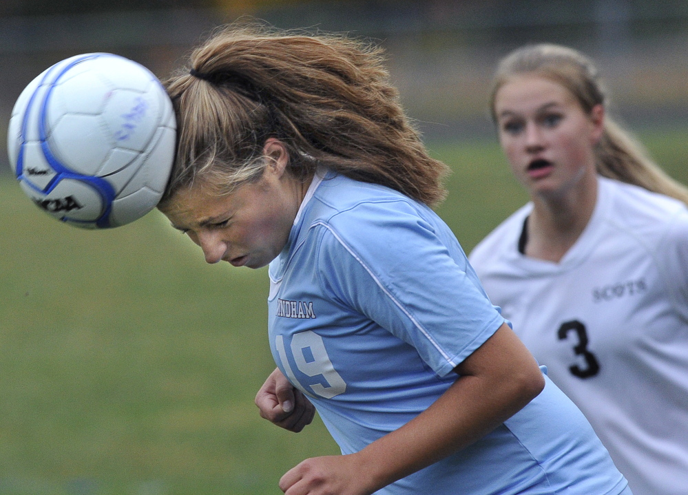 Sarah Rich of Windham heads the ball away from Desiree Wright of Bonny Eagle during their SMAA girls’ soccer game Wednesday at Standish. Windham, the defending state champ, remained undefeated with an 8-0 victory.