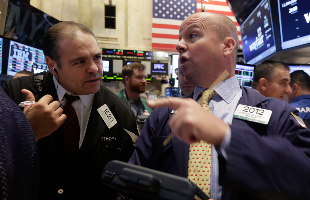 Traders Anthony Riccio, left, and Patrick Casey work Thursday on the floor of the New York Stock Exchange in the wake of a selloff the day before.