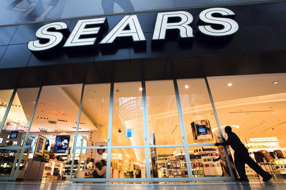 The Sears store at Eaton Centre in Toronto opens its doors for business in this Oct, 29, 2013, file photo. Sears, sorely in need of cash, is selling most of its stake in its Canadian unit to raise as much as $380 million. 
