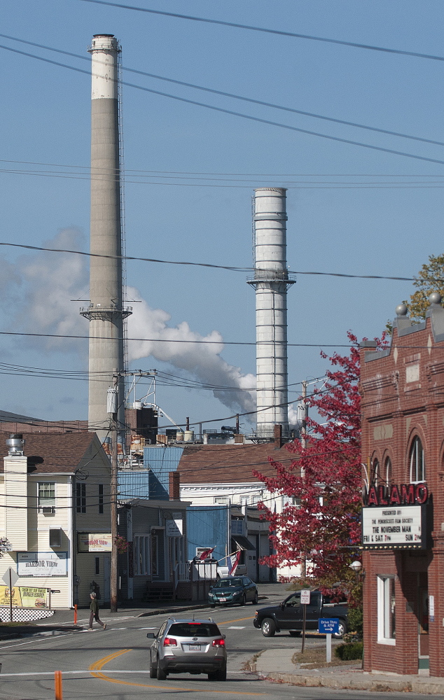 The Verso Paper mill’s smokestacks loom over the town of Bucksport on Thursday, one day after Verso announced it will close the mill Dec. 1.