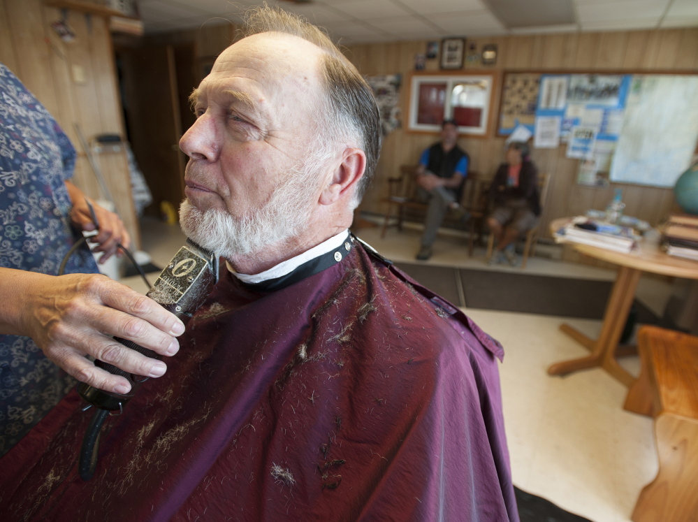 n Barber Frank Dunbar, a town councilor who has run a barber shop on Main Street in Bucksport for more than 50 years, says, “We’ve been living in (the mill’s) shadow all these years.”