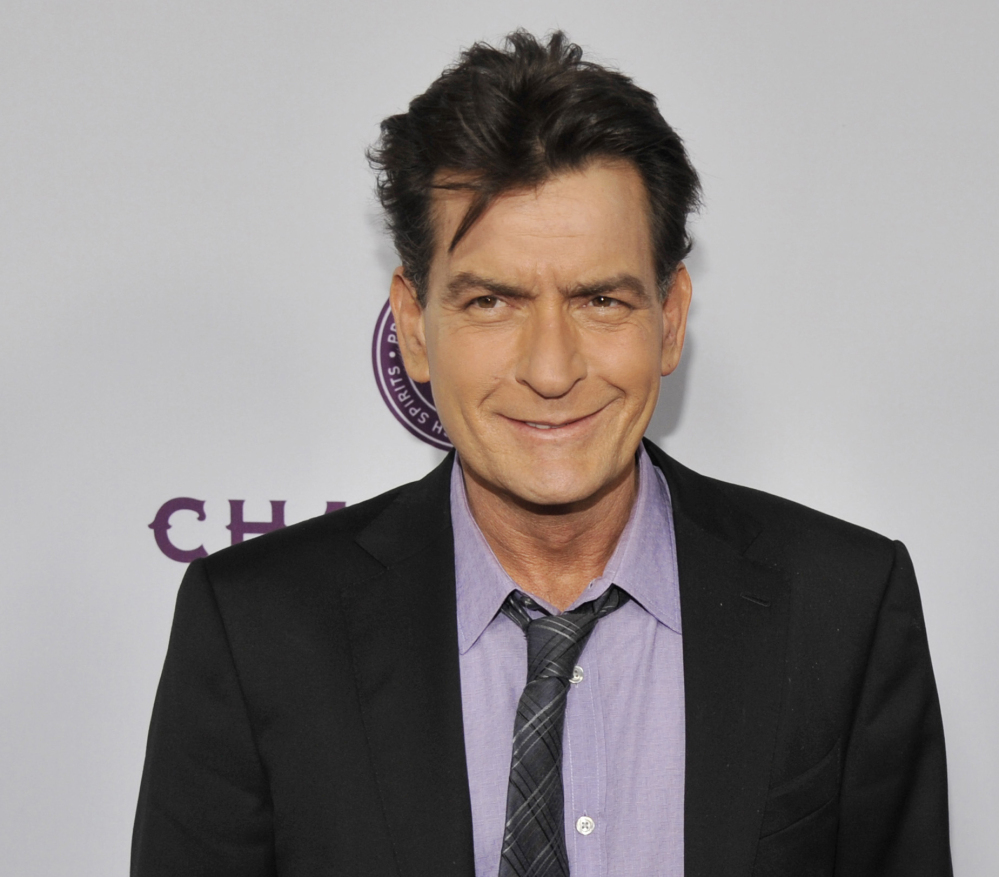 Charlie Sheen is being sued by a dental technician who claims he punched her and grabbed her bra.