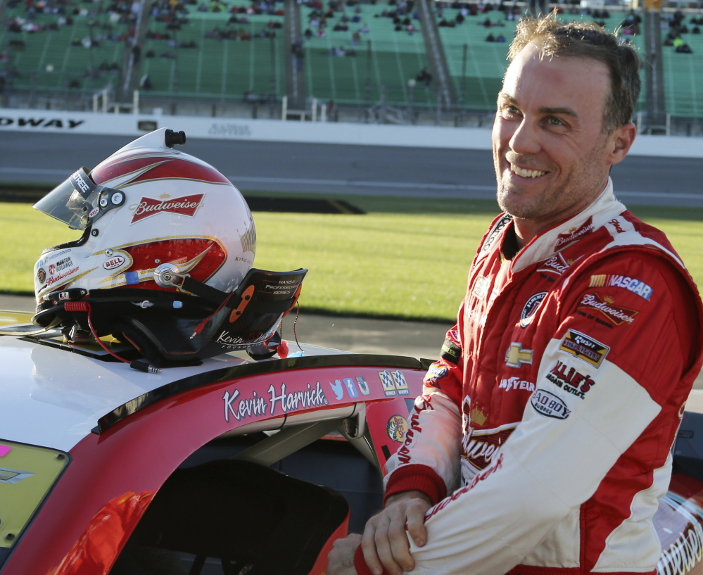 Kevin Harvick smiles after winning the pole position for Sunday’s NASCAR Sprint Cup race at Kansas Speedway in Kansas City, Kansas, on Friday.