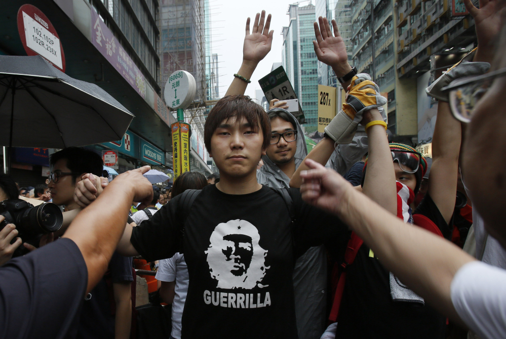 A pro-democracy student protester stands firm as he is insulted by local residents in Mong Kok, Hong Kong, on Saturday.