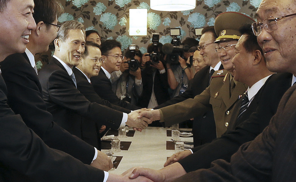 South Korean officials, left, and North Korean members of the government meet Saturday. It was the highest level face-to-face talks between the countries in five years.