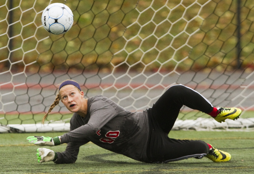 Emma Russell of South Portland keeps her eyes on the ball after diving to make a save Saturday during the girls’ soccer game against Portland at Fitzpatrick Stadium. Russell finished with eight saves for the Red Riots in a 1-0 setback.