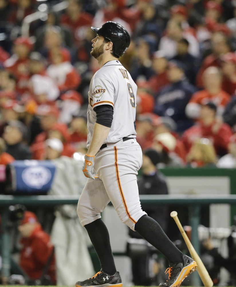 Brandon Belt of the San Francisco Giants watches the flight of the ball Saturday night. He hit a home run in the 18th inning that defeated the Washington Nationals 2-1 for a 2-0 series lead.